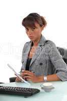 Serious office manager sat at her desk