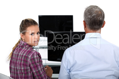 Businessman and a young woman in front of a computer