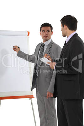 Two businessmen with a flipchart