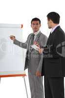 Two businessmen with a flipchart
