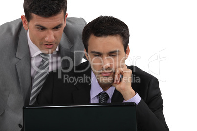 Businessmen looking at a laptop