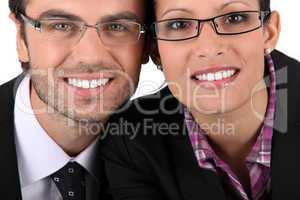 Smiling man woman wearing pairs of eyeglasses