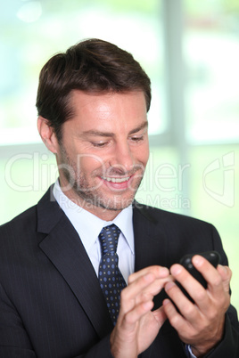 Man in suit looking at mobile