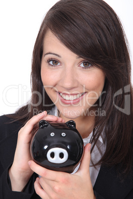 Brunette woman with piggy bank