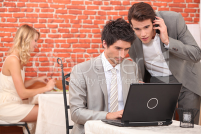 Businessmen connecting with laptop computer