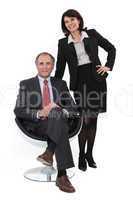 businessman and businesswoman posing together