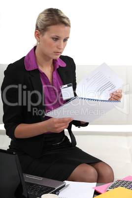 Young businesswoman looking through a report