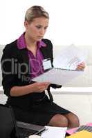 Young businesswoman looking through a report