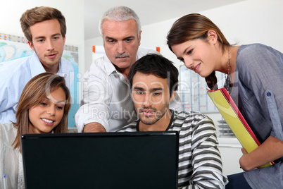 group of people watching a screen