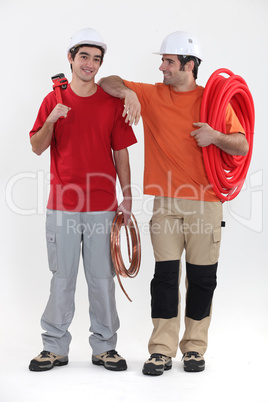 Two plumbers stood together