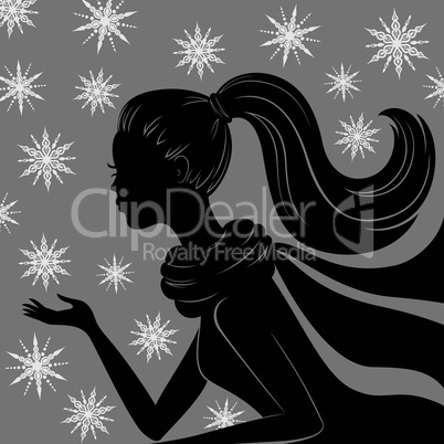 Silhouette of young woman with flying snowflakes