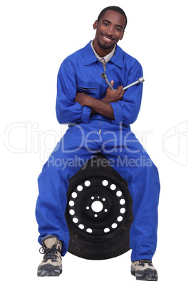 Mechanic sitting on a wheel