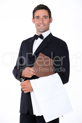 Well-dressed waiter holding menu