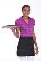 Waitress in a cafe holding an empty tray