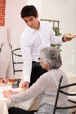 Waiter serving food