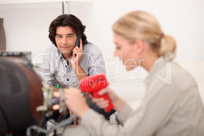 female technician working while the client is talking on the phone