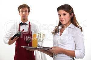 Wine waiter and waitress, studio shot