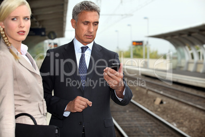 Business couple waiting for a train