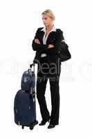 Businesswoman with luggage waiting