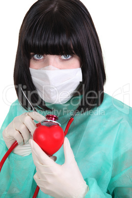 Surgeon listening to a heart's heartbeat