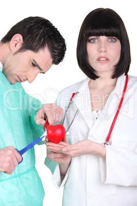 Doctors with plastic heart