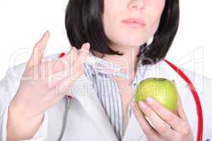 Doctor injecting hormone drugs into an apple