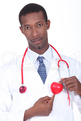 Male doctor stood with plastic heart