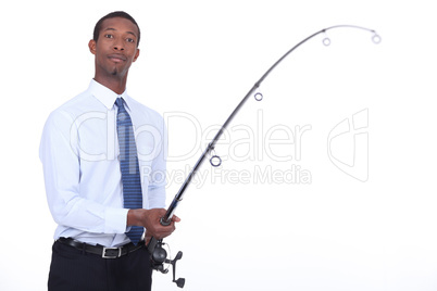 Man in a shirt and tie using a fishing rod