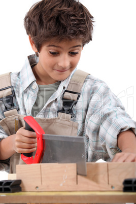 Closeup of a young boy sawing word