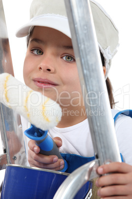 Young child dressed in adult's decorating clothes