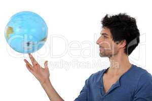 Man with a globe spinning
