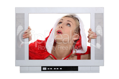 Woman with Christmas layer frame behind TV