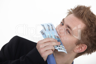 Successful business man smelling money
