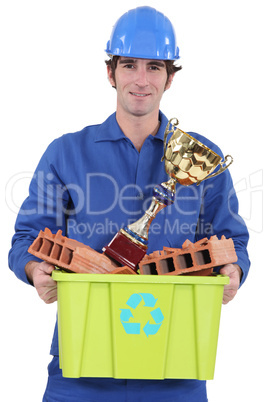 Builder with an award for recycling material