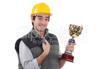 craftsman holding a trophy