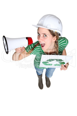 Woman with recycle poster shouting into megaphone