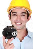 Builder holding piggy-bank