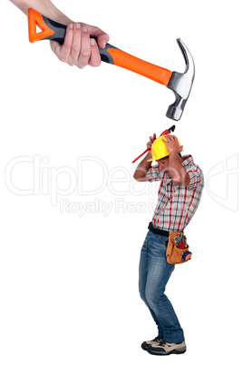 Builder being attacked by giant hammer