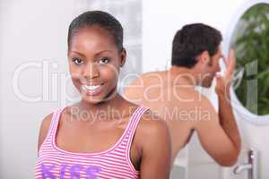black woman and his boyfriend in the bathroom, the man has a wash