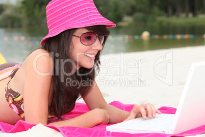 Girl with pink hat and computer