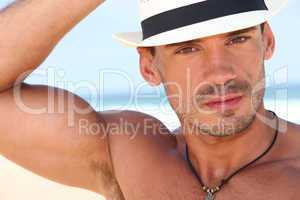 Muscled young man with a hat