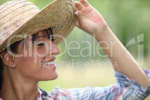 Young woman in a straw hat