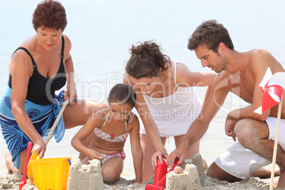 Family making sandcastle