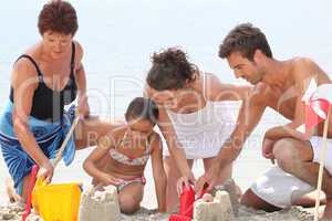 Family making sandcastle