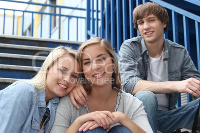 Teenagers sat on the steps