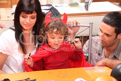 Parents and son preparing Halloween party