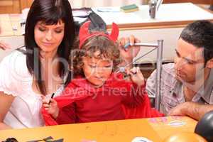 Parents and son preparing Halloween party
