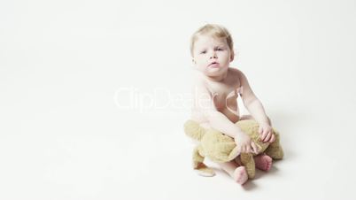 Baby Girl Sitting With Plush Toy, Then Walks Out