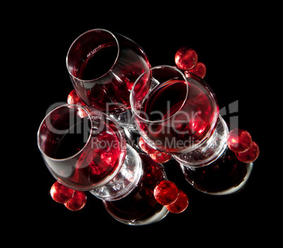 Glasses of wine and chocolate on a black background