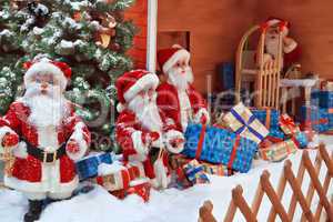 The group of Santa Clauses with gifts
